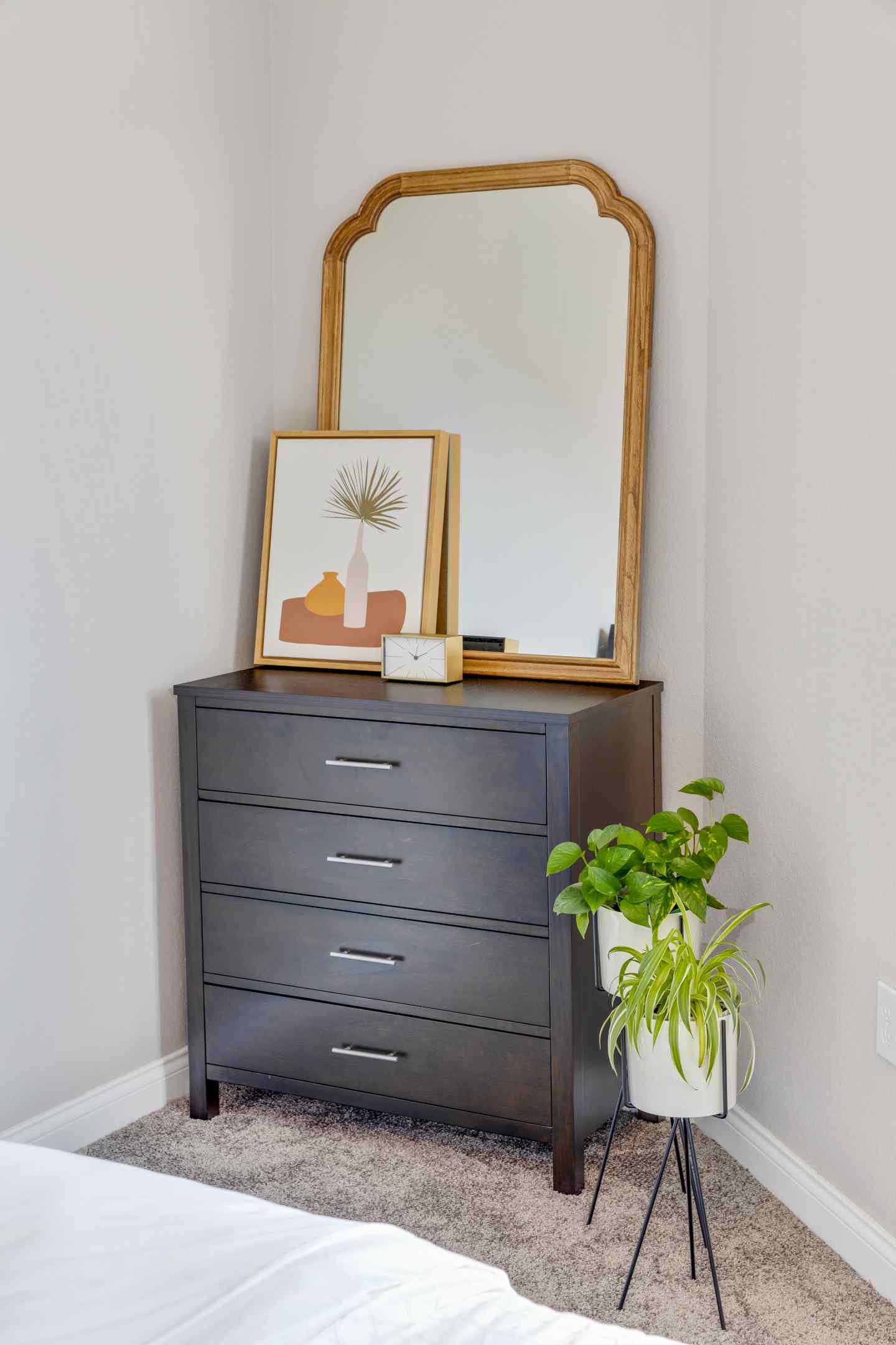 A zoomed in picture of a well decorated dresser in a student's bedroom.