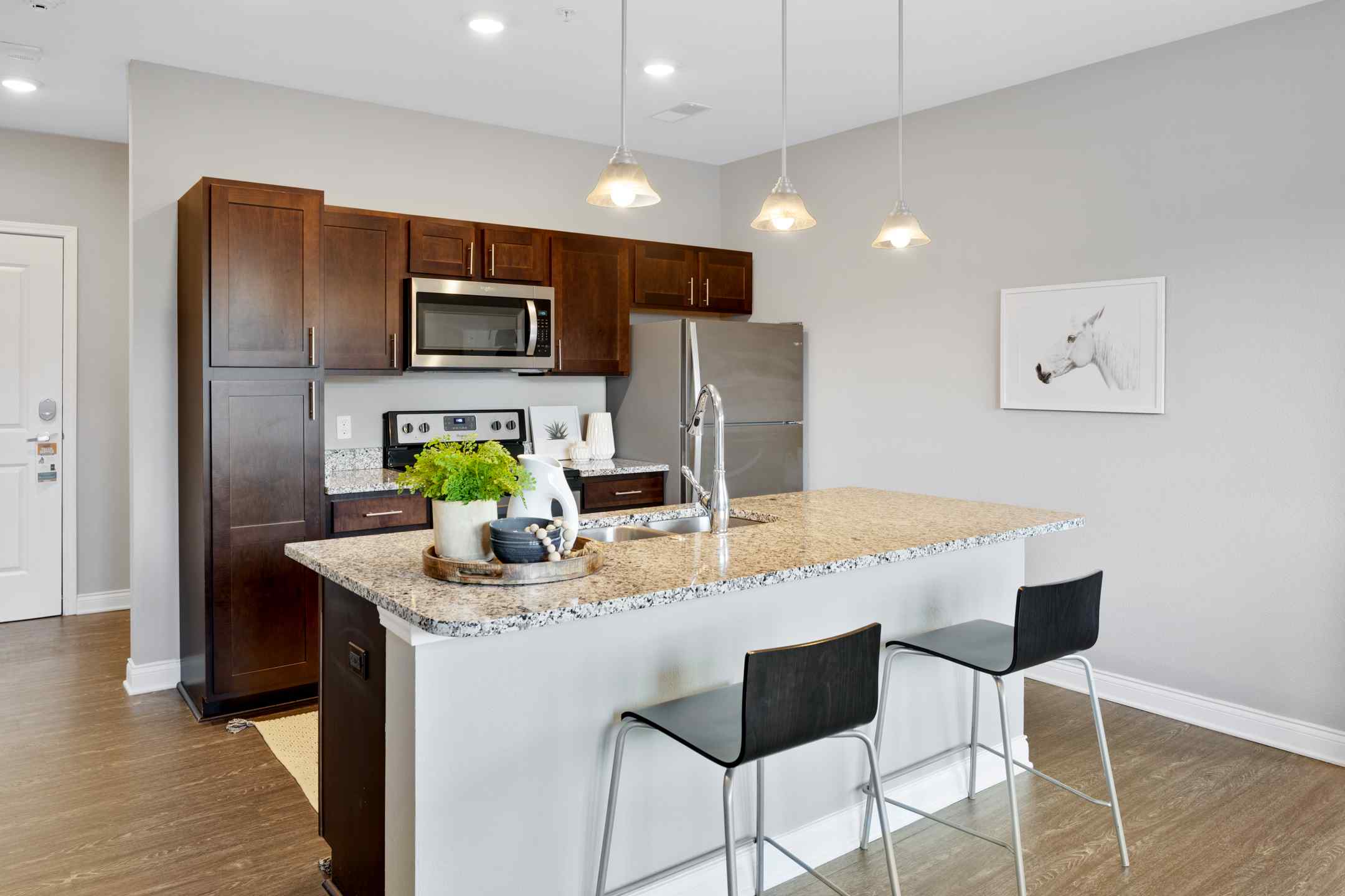 A large kitchen island with bar seating, and a fully equipped kitchen.