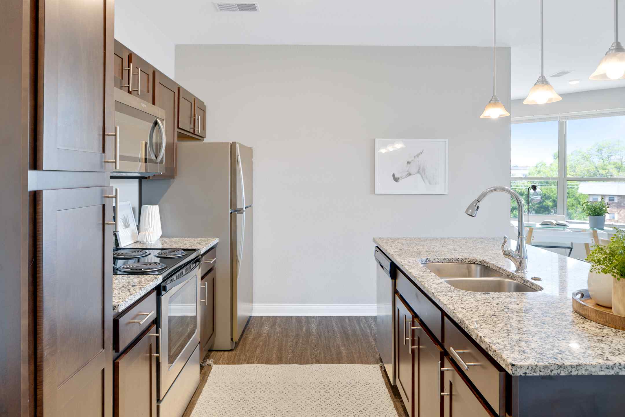 A large kitchen island with bar seating, and a fully equipped kitchen.