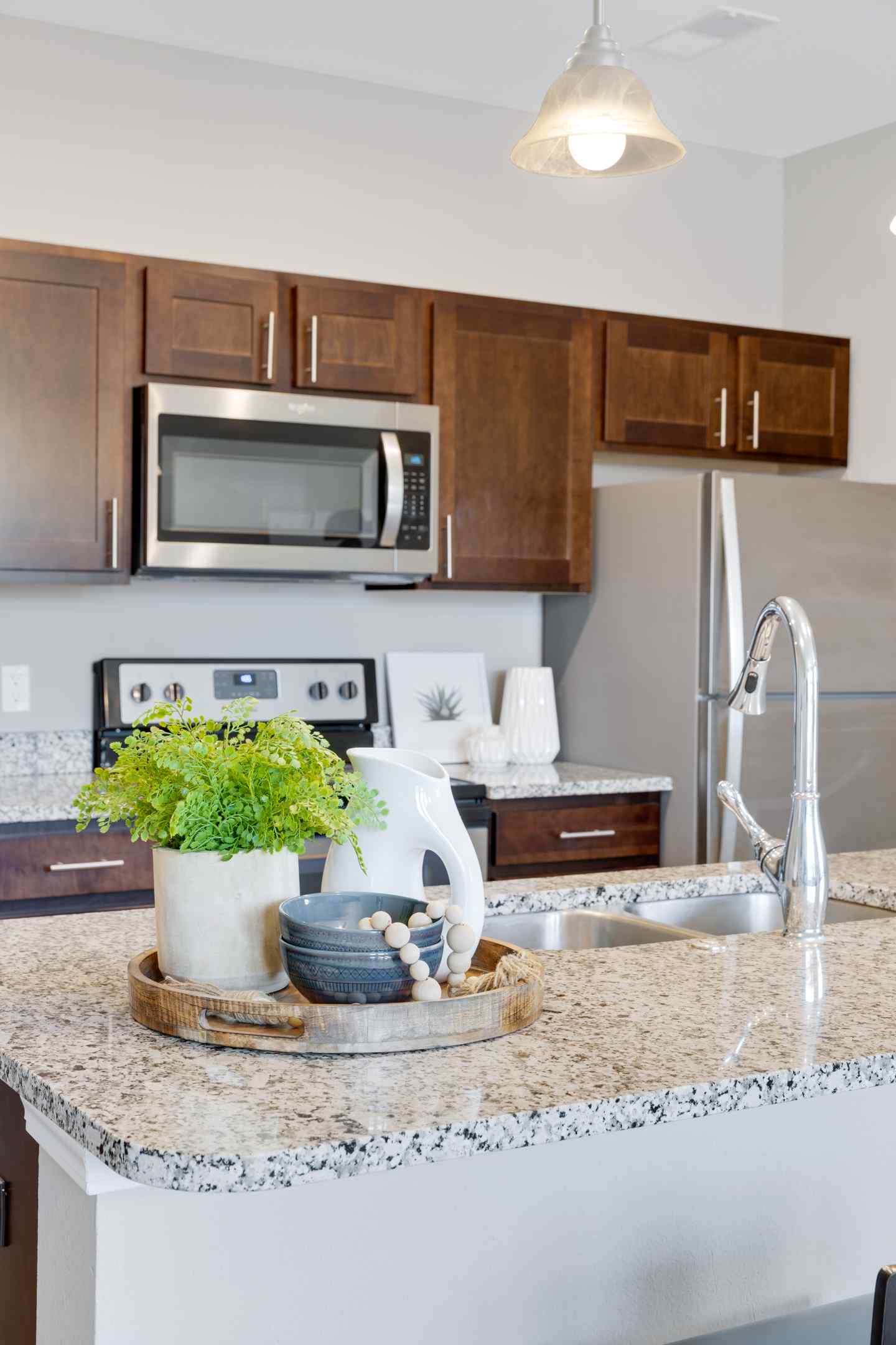 A large kitchen island with bar seating, and a fully equipped kitchen.