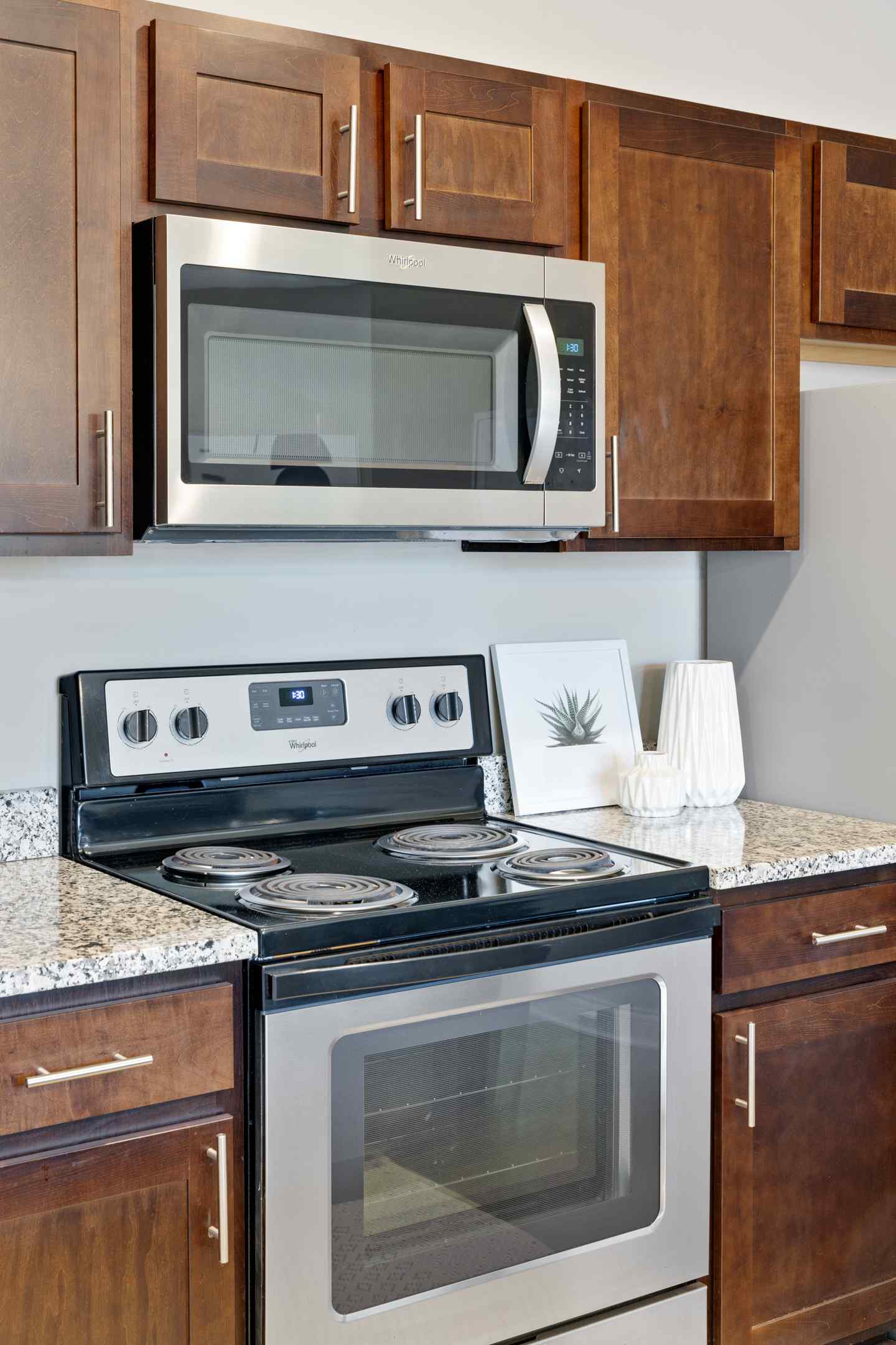 Newly renovated apartment kitchen equipped with modern appliances, including an oven and microwave.
