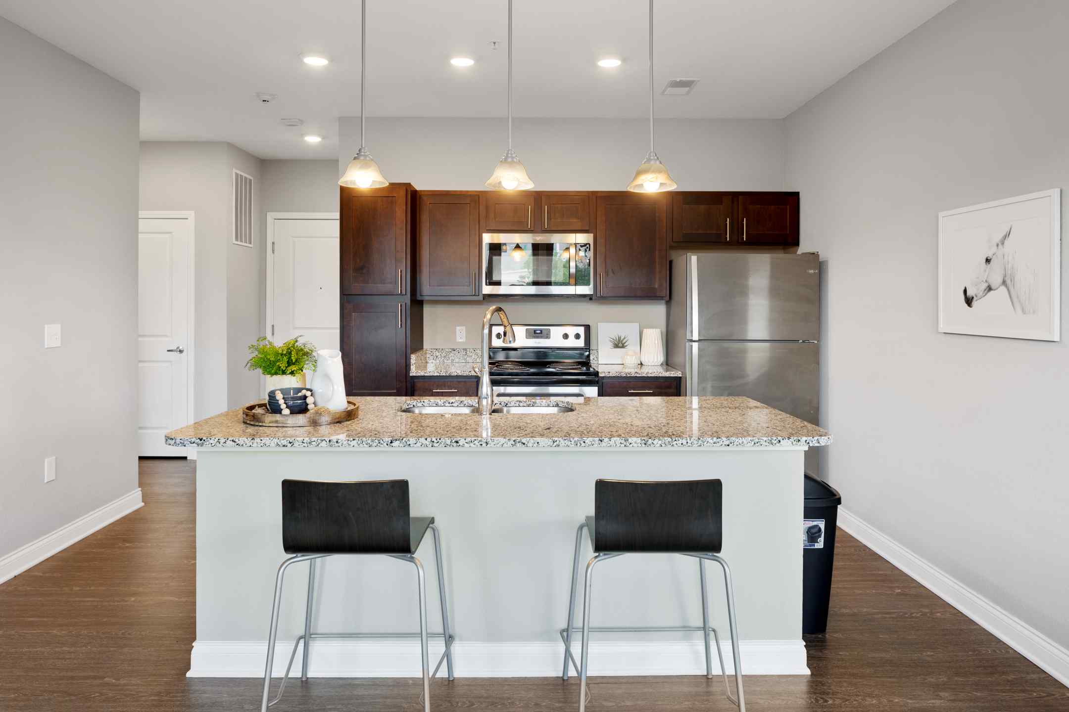 A large kitchen island with bar seating, and a fully equipped kitchen.